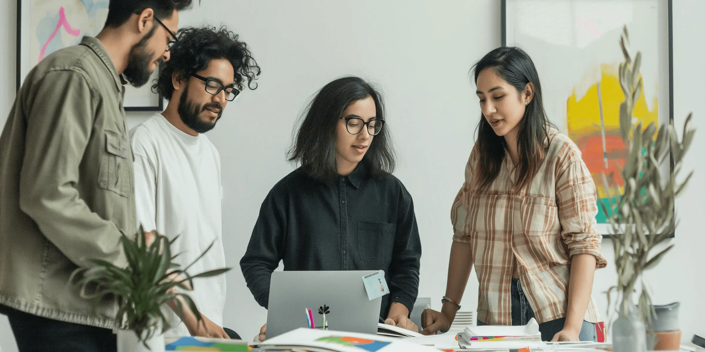 A team working together around a laptop